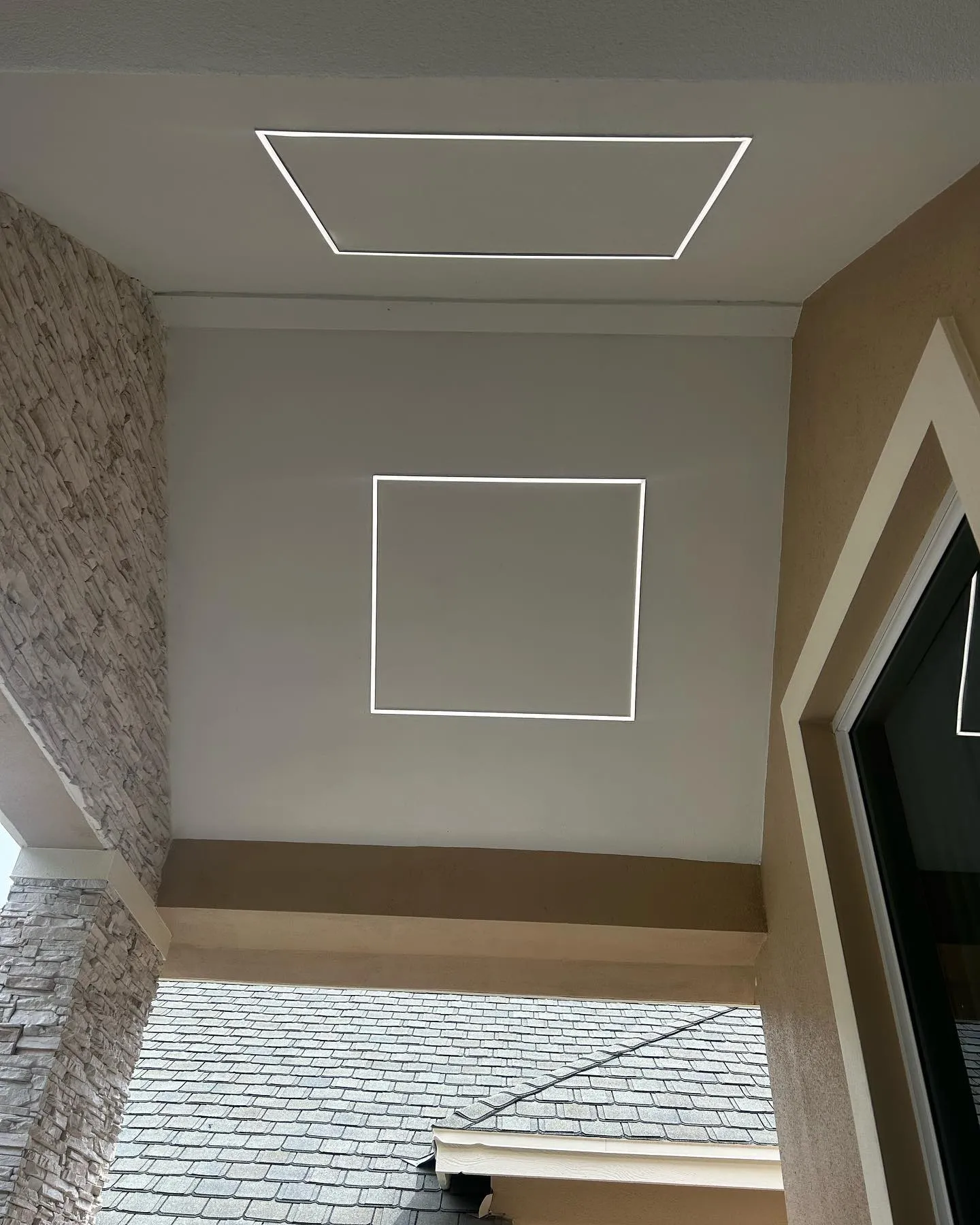 A square LED frame light glowing in a white ceiling