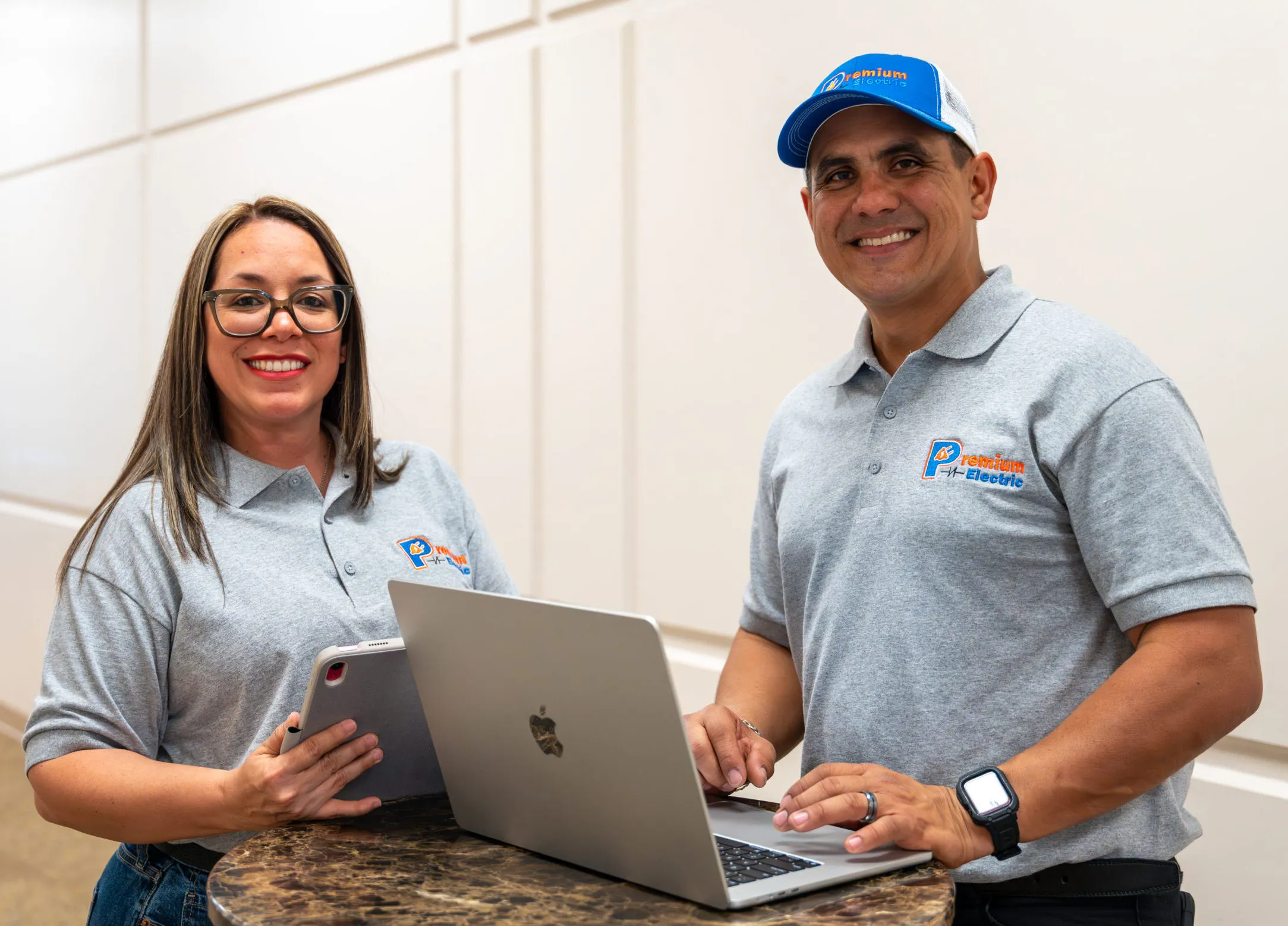 Ronny and Angie at a desk with a laptop, planning a job