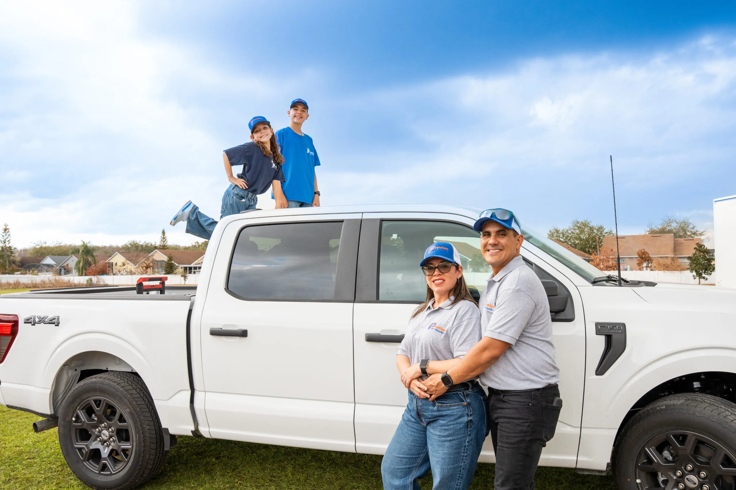 Ronny, Angie, and the kids with their white pickup truck